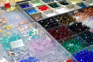 Many different colored beads are on display in bins