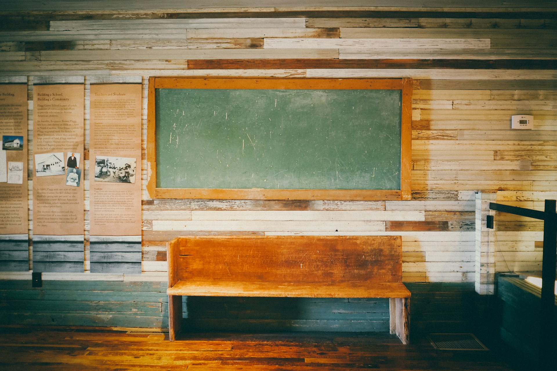 An empty classroom with a chalkboard on the wall