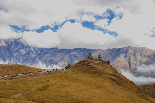 A grassy hill with a building on top of it