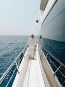 Two people standing on the deck of a boat