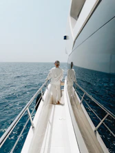 Two people standing on the deck of a boat