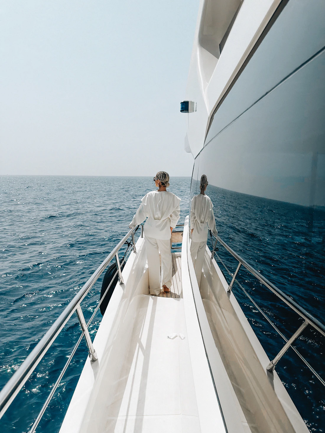 Owners walking the foredeck of a superyacht at sea