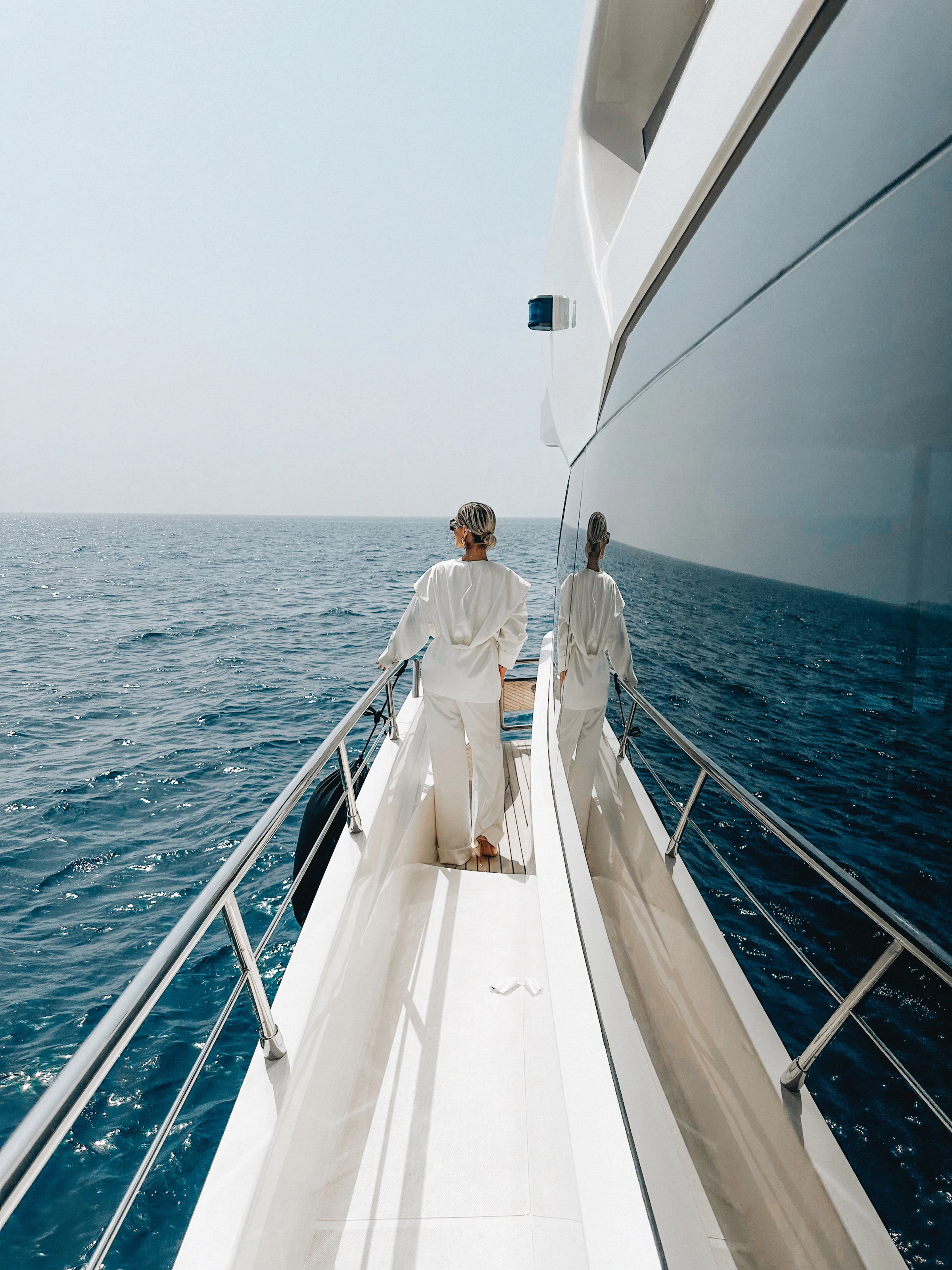 Owners walking the foredeck of a superyacht at sea