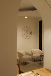 A room with a table, chairs, and a clock