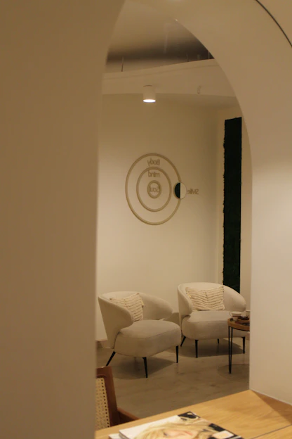 A room with a table, chairs, and a clock