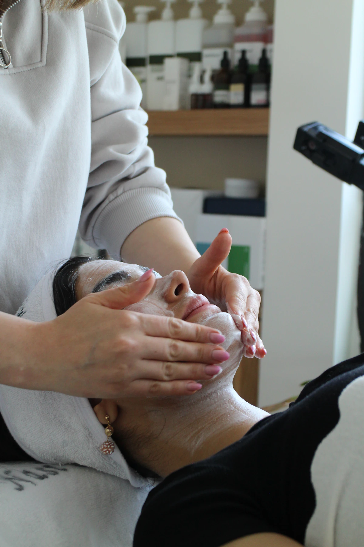 Woman receiving a facial mask treatment for pore and texture care