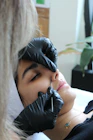 A woman getting her nose examined by a doctor