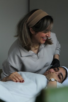 A man laying in a bed next to a woman
