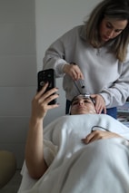 A woman getting her hair cut by a hair stylist