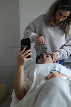A woman getting her hair cut by a hair stylist