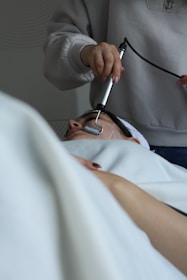A woman getting her hair brushed by a hair stylist