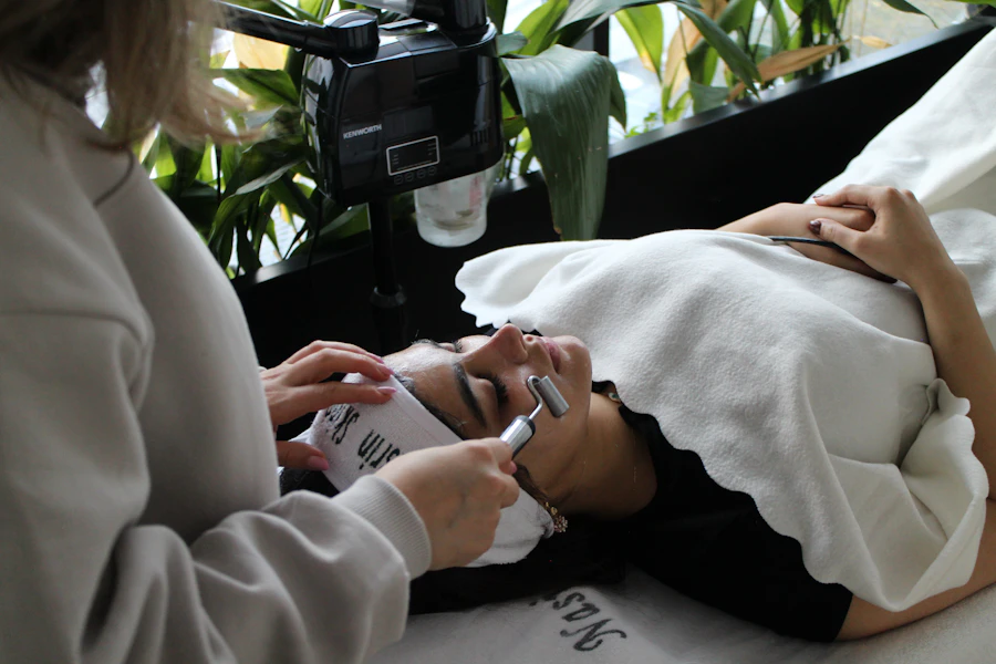 A woman laying on a bed while using a cell phone