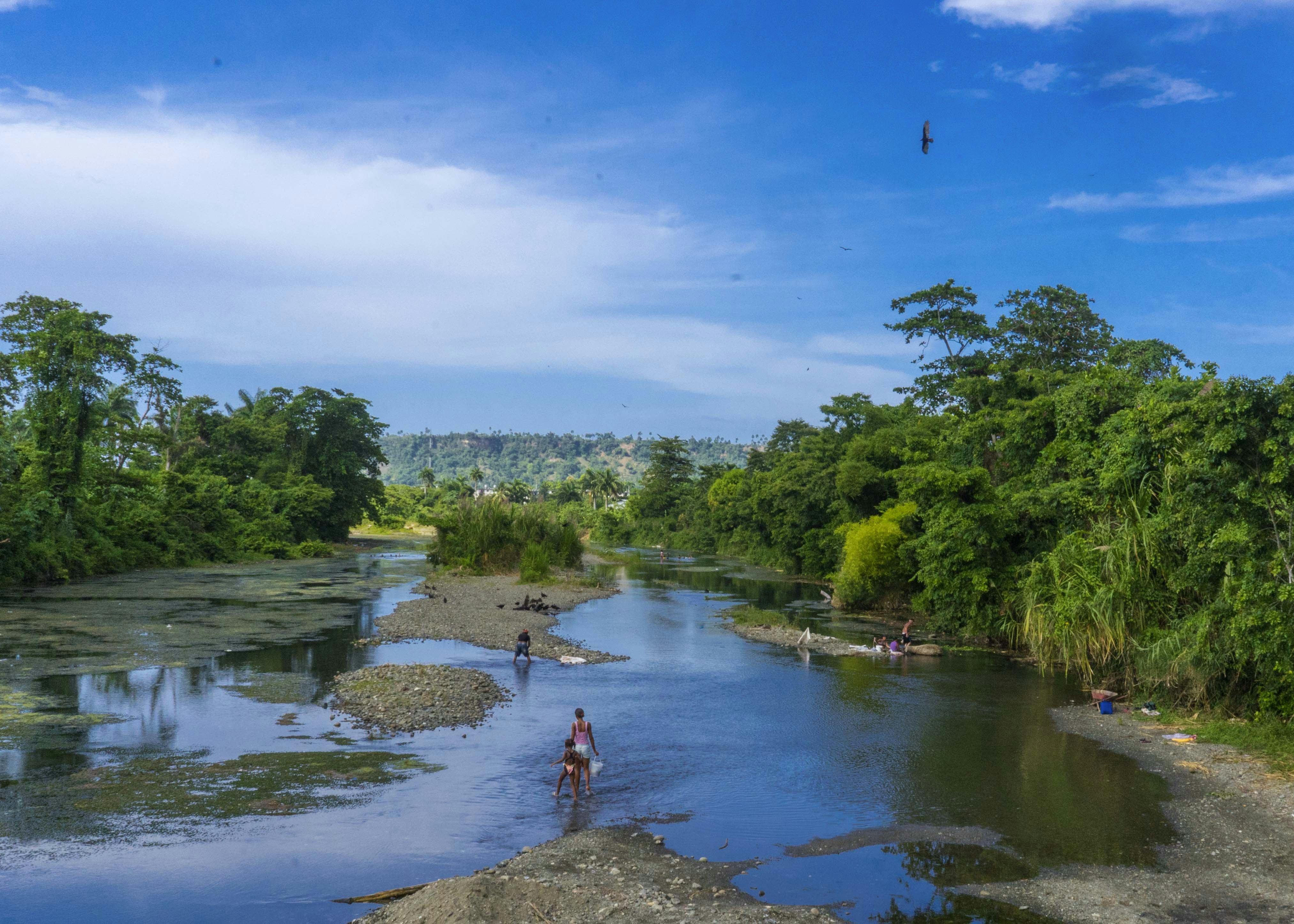 A man standing on the edge of a river