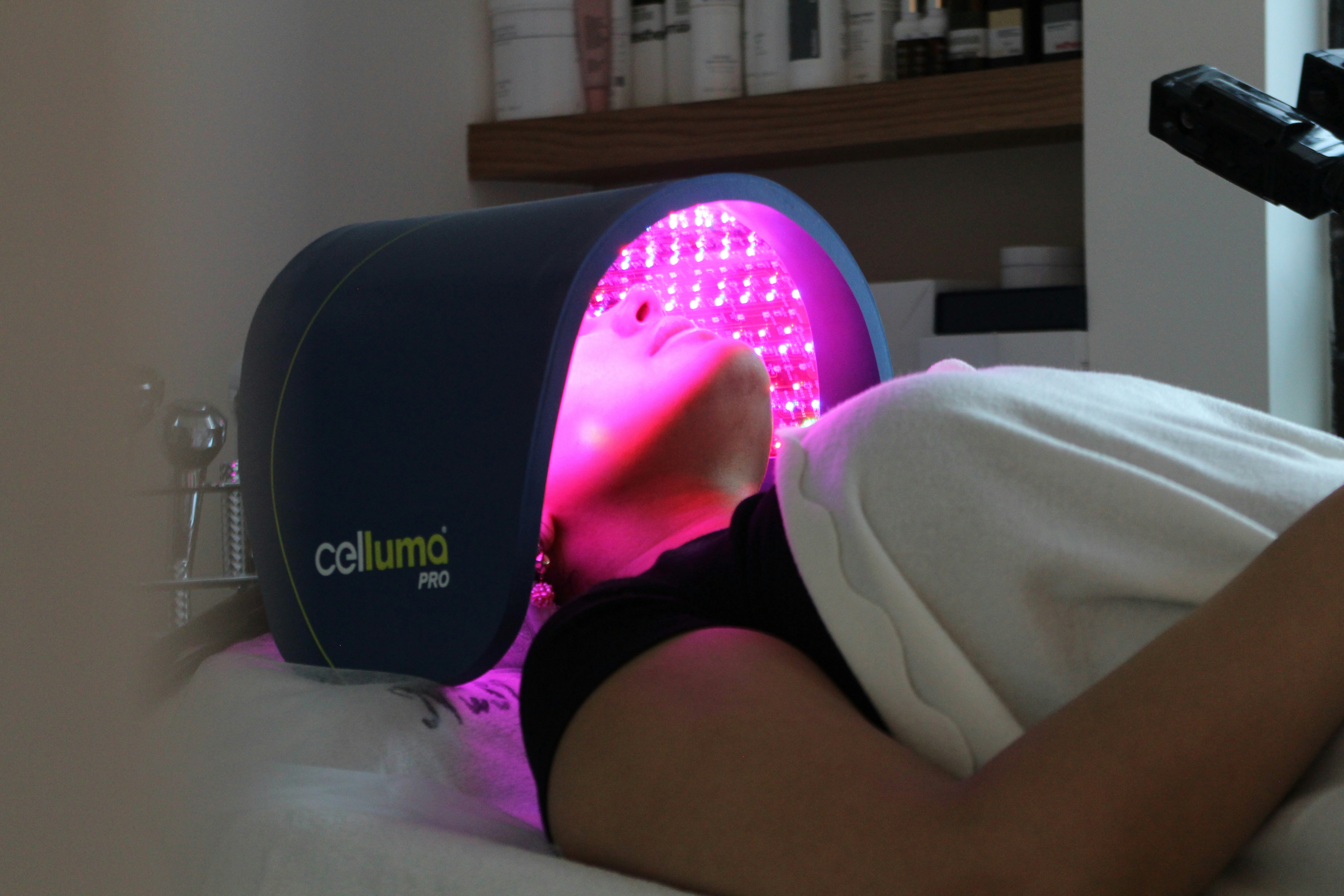 A professional performing a cellulite reduction treatment on a client's leg.