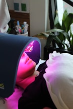 A woman laying in bed with a bright light on her head