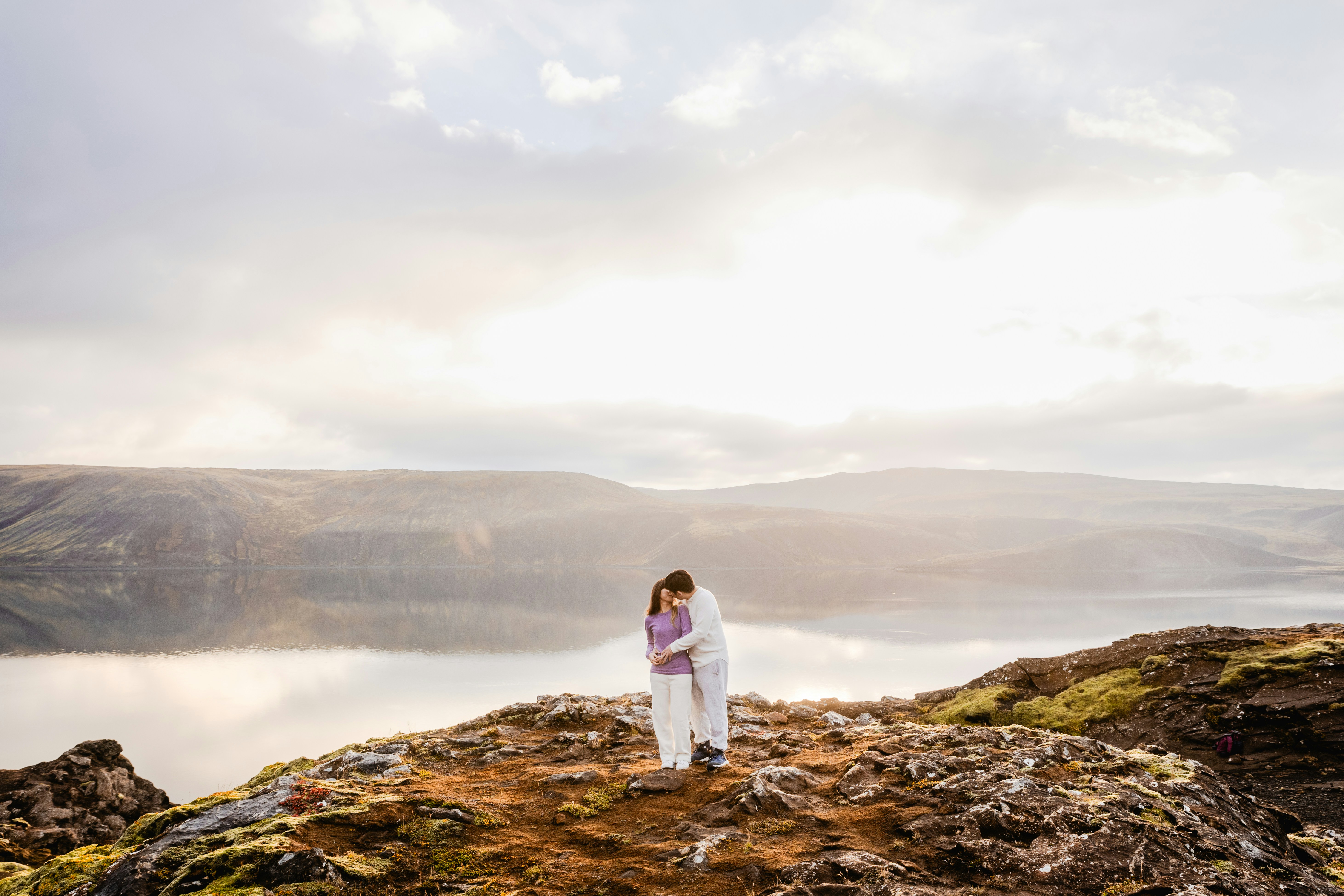 A woman standing on top of a rocky cliff