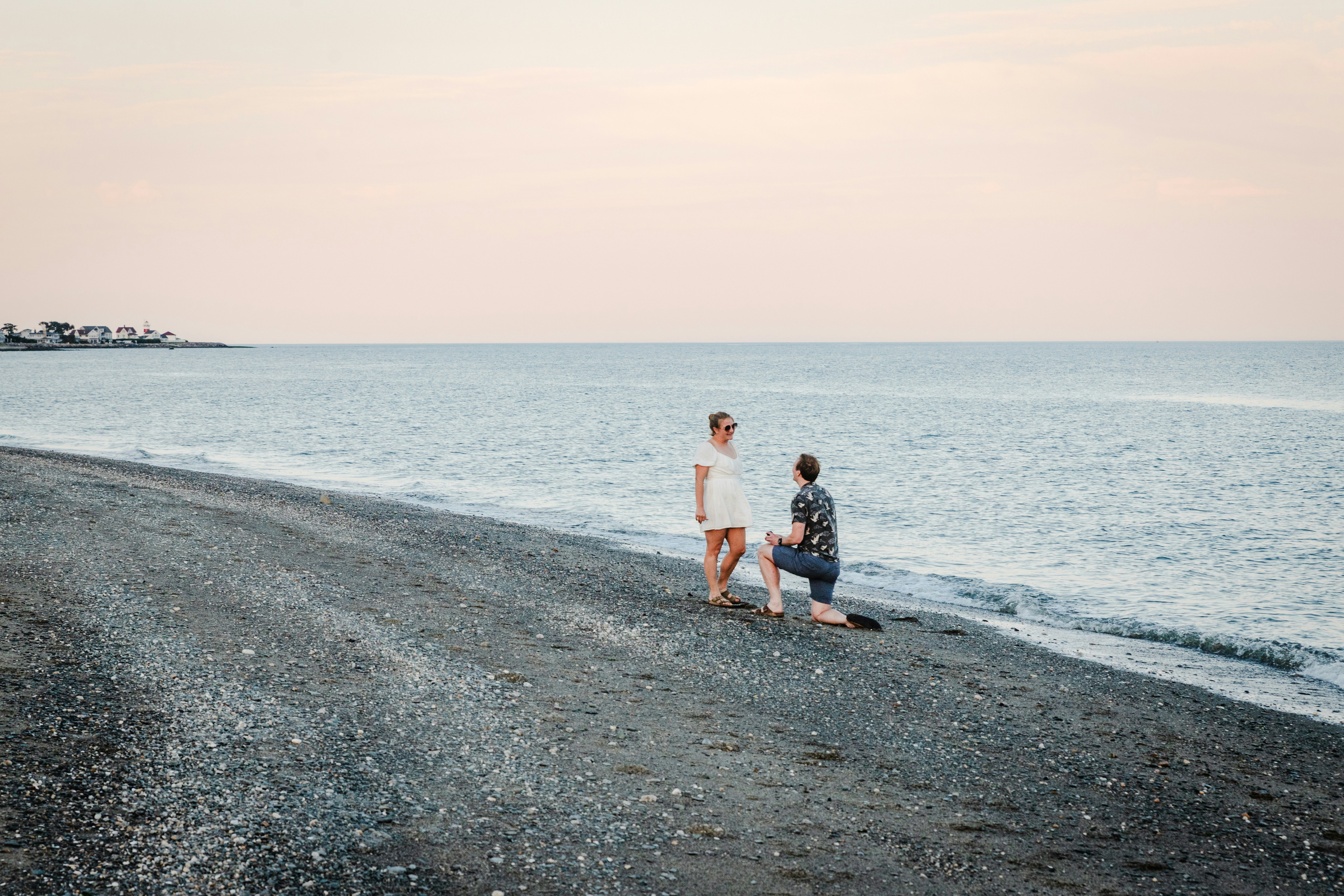 A couple of people that are walking on a beach