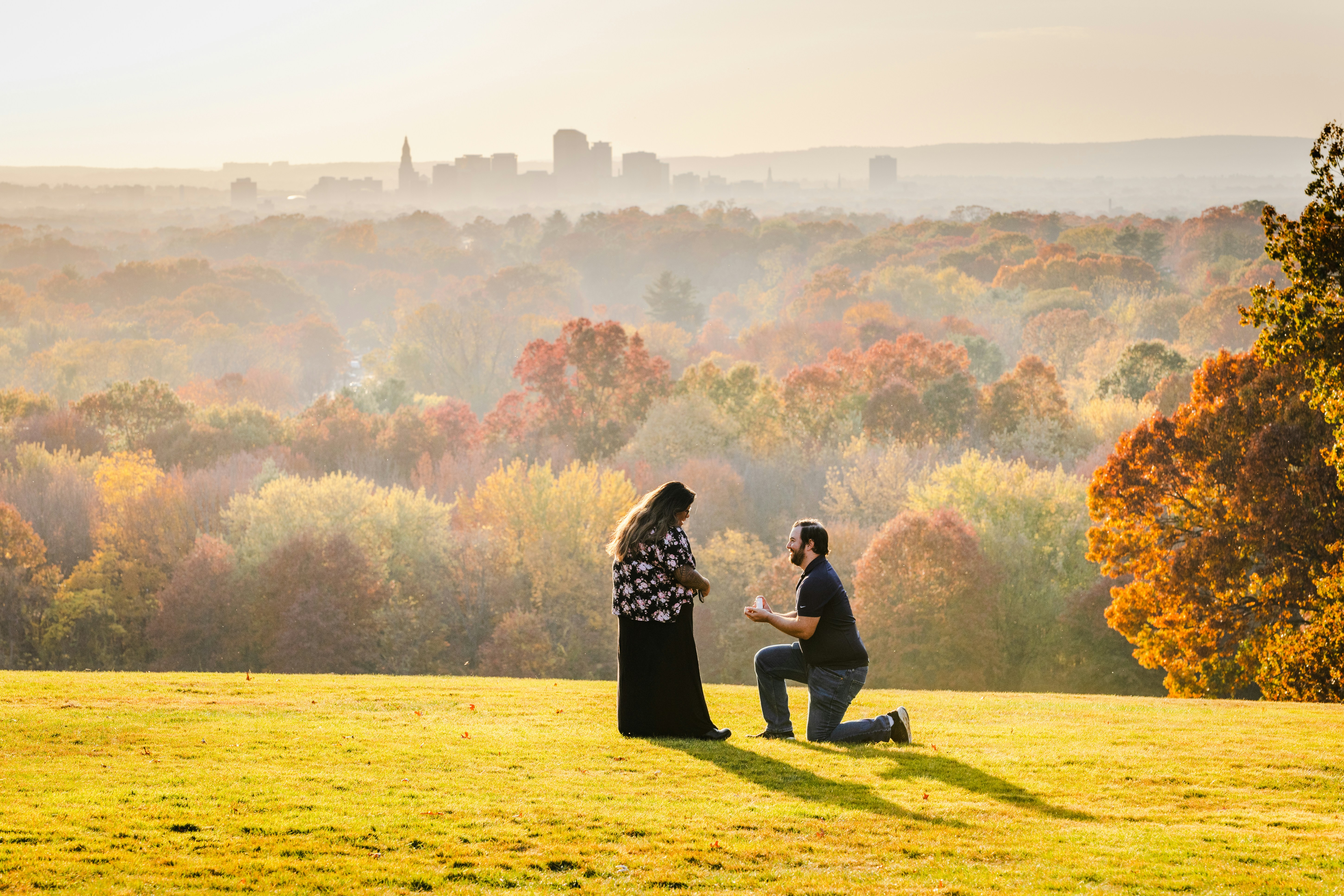 A couple of people that are standing in the grass