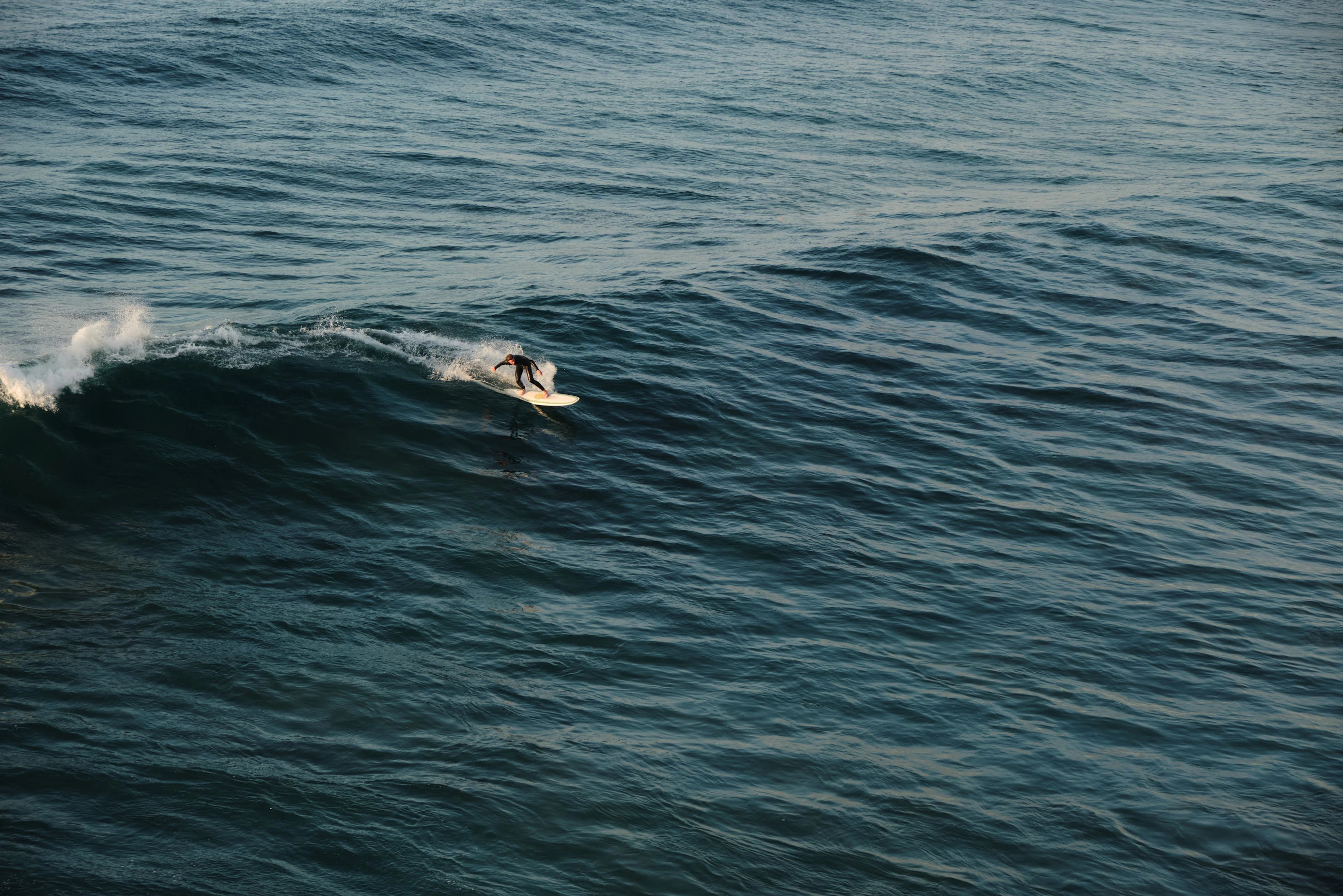 Surfer riding through a breaking ocean wave