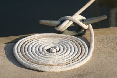 A close up of a white rope on a dock