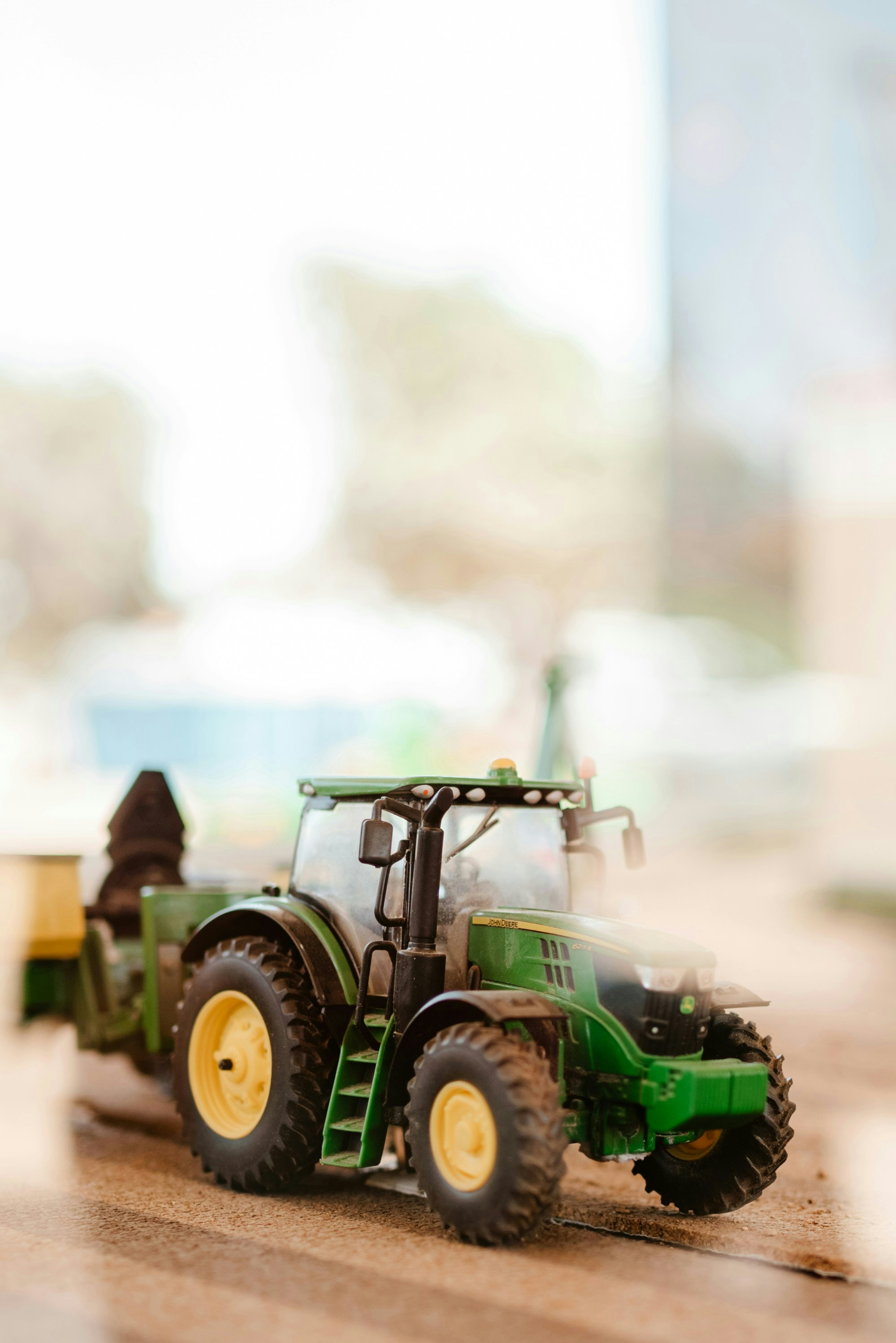 A toy tractor with a trailer attached to it