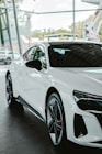 A white sports car parked in a showroom