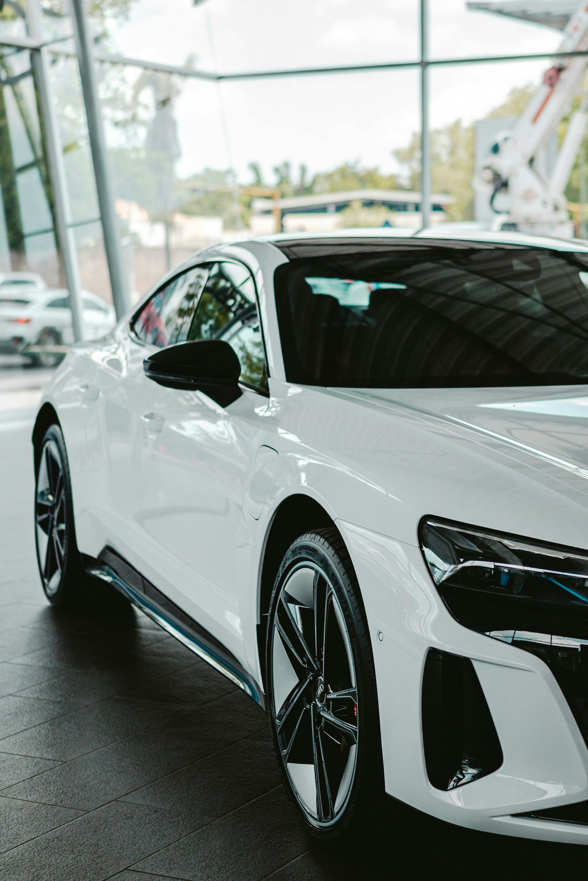 A white sports car parked in a showroom