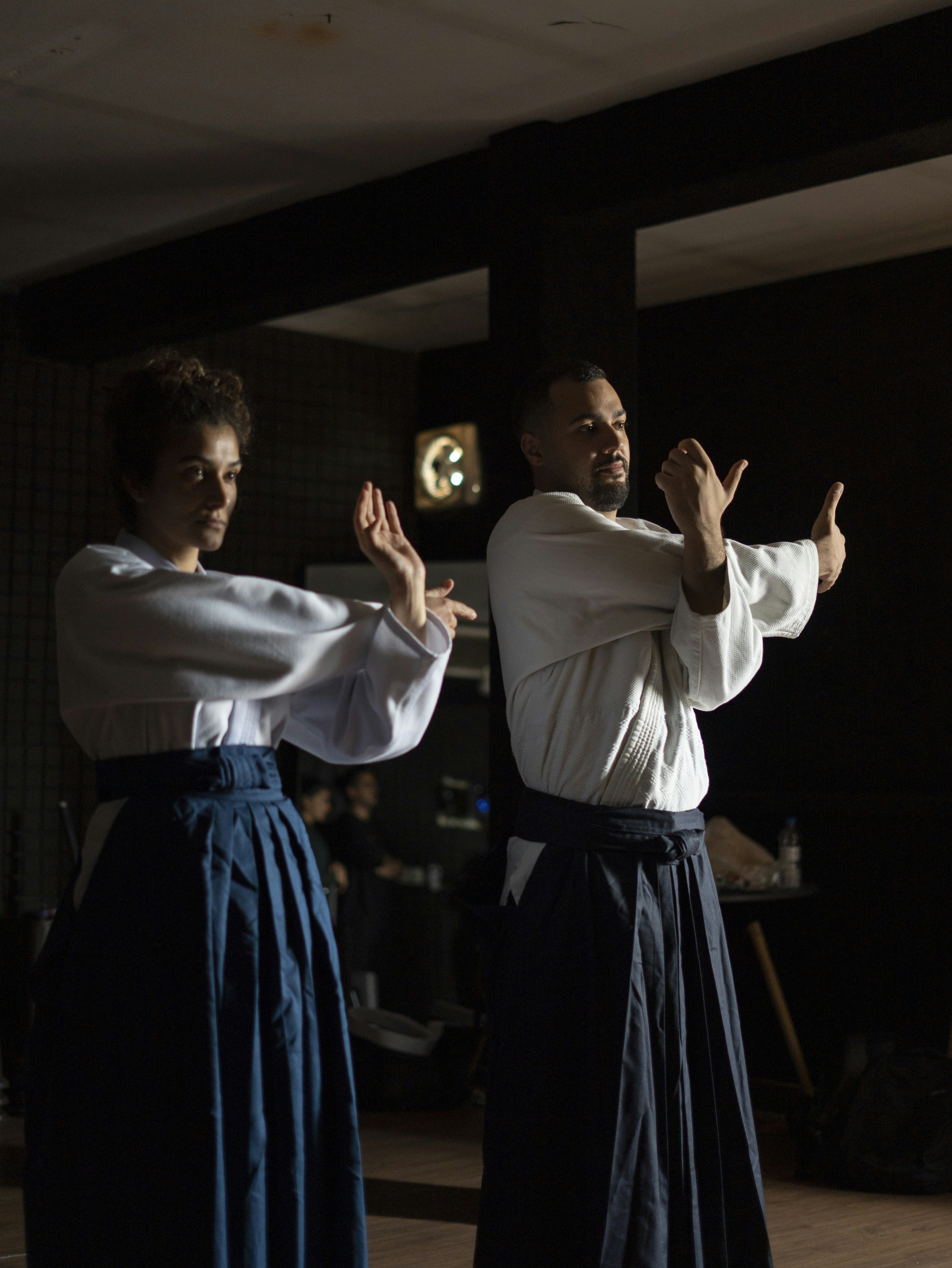 A couple of people standing on top of a wooden floor