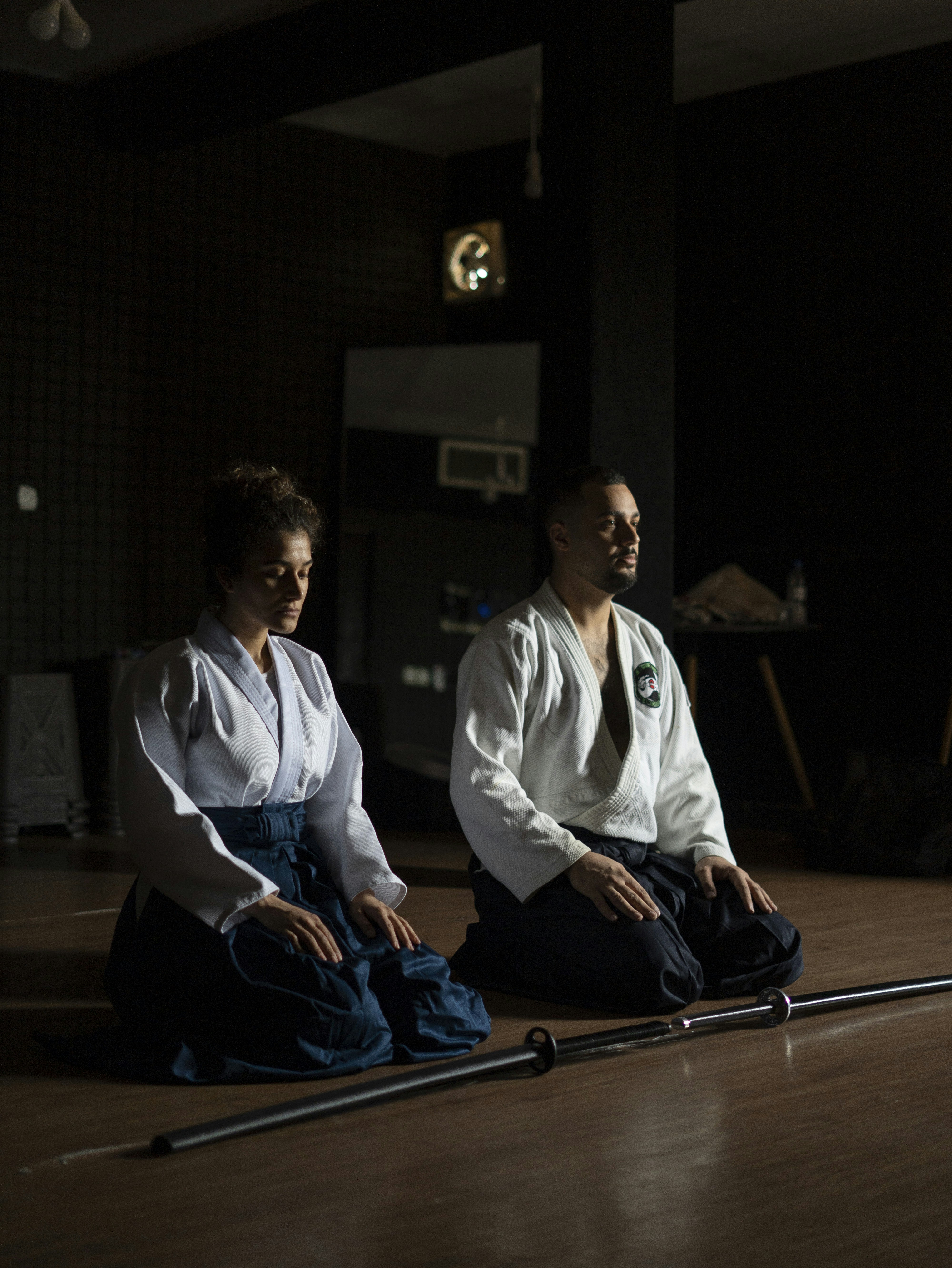 Two people sitting on the floor in a room