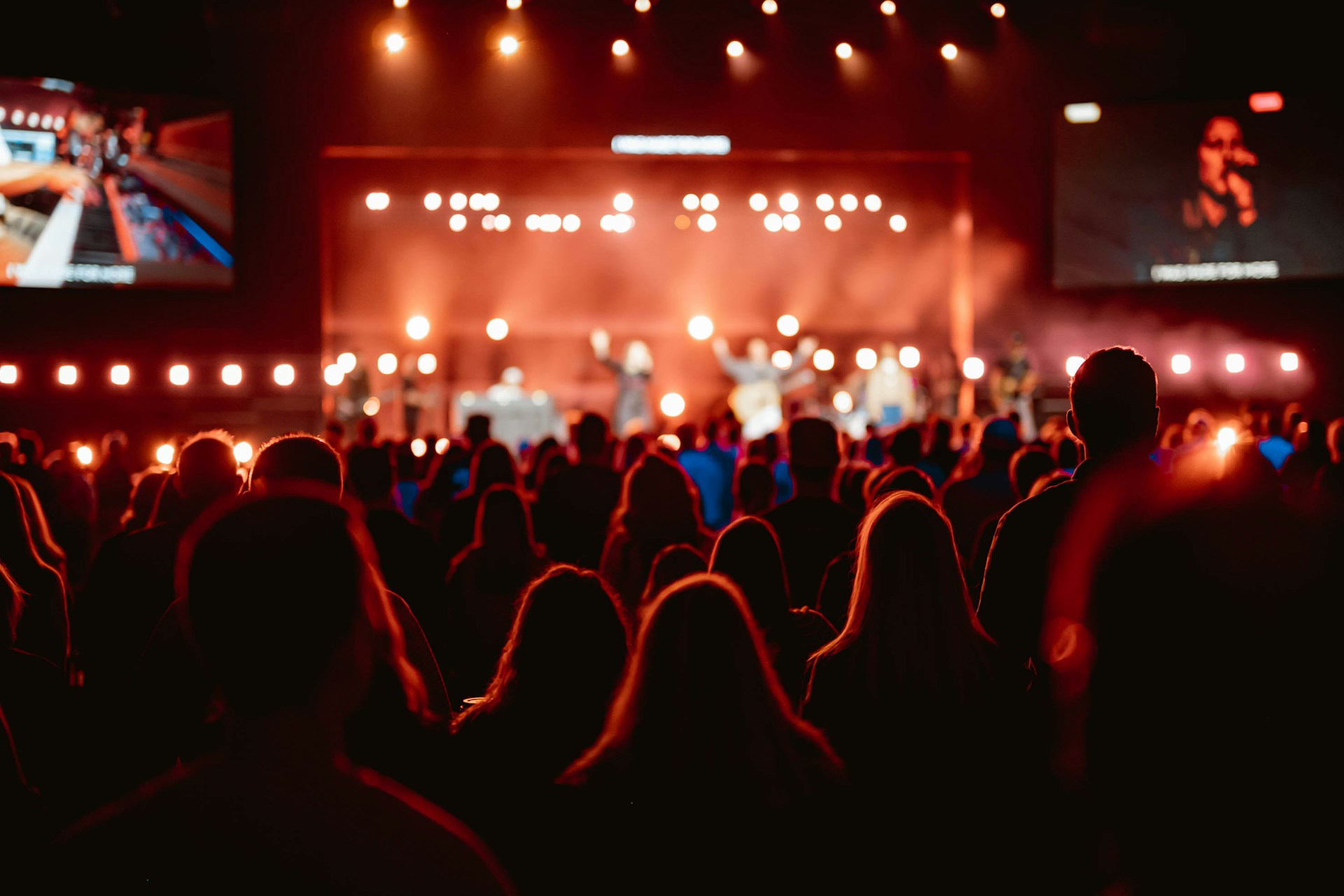 A crowd of people watching a concert on stage