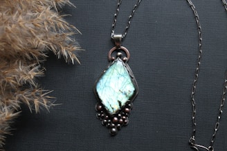 A couple of necklaces sitting on top of a table