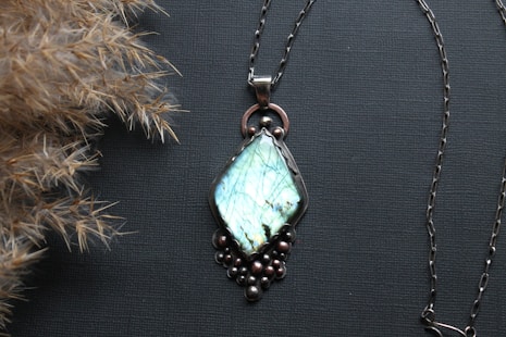 A couple of necklaces sitting on top of a table