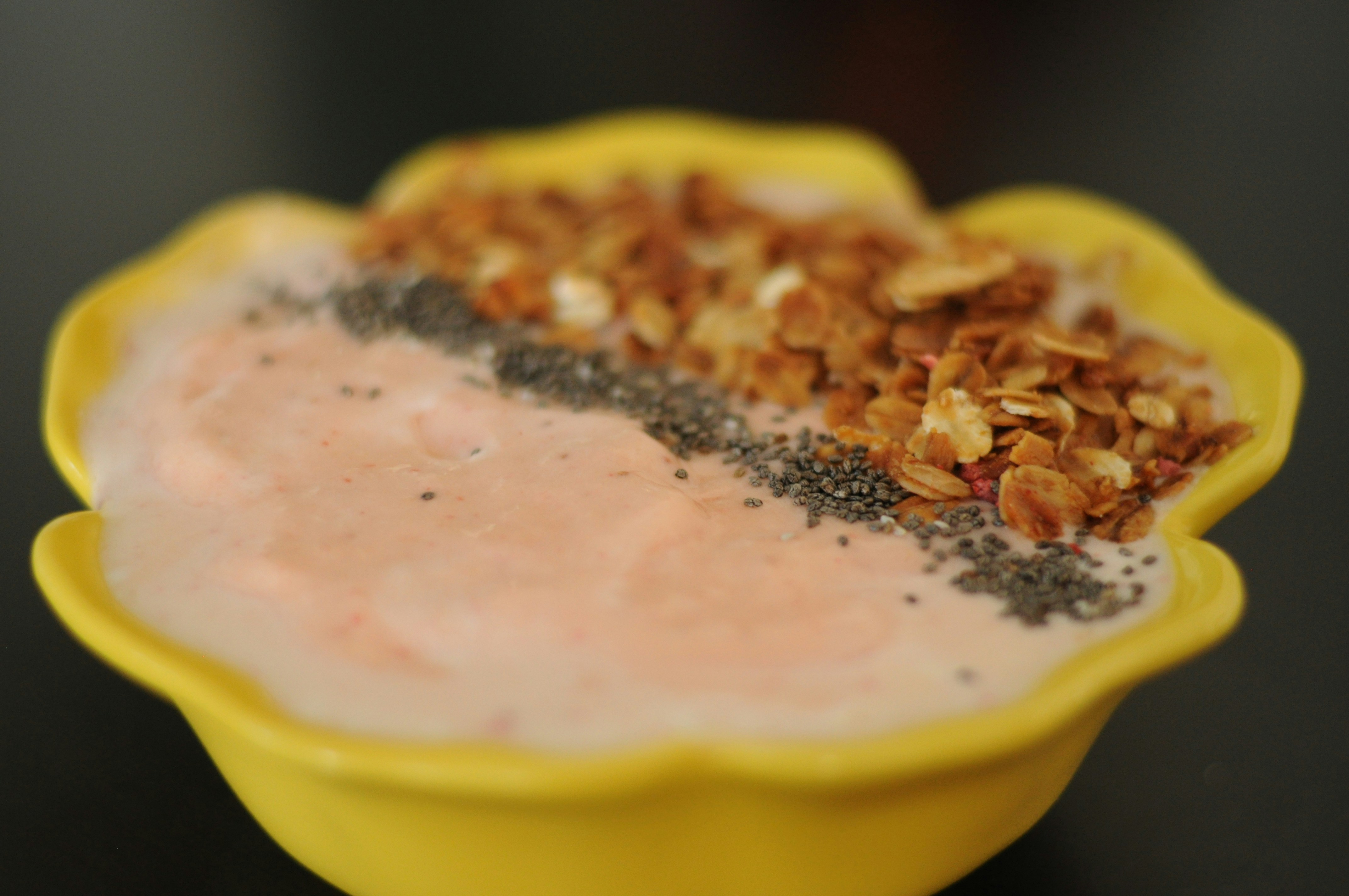 A yellow bowl filled with food on top of a table