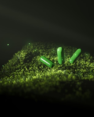 A group of green pills sitting on top of a moss covered ground