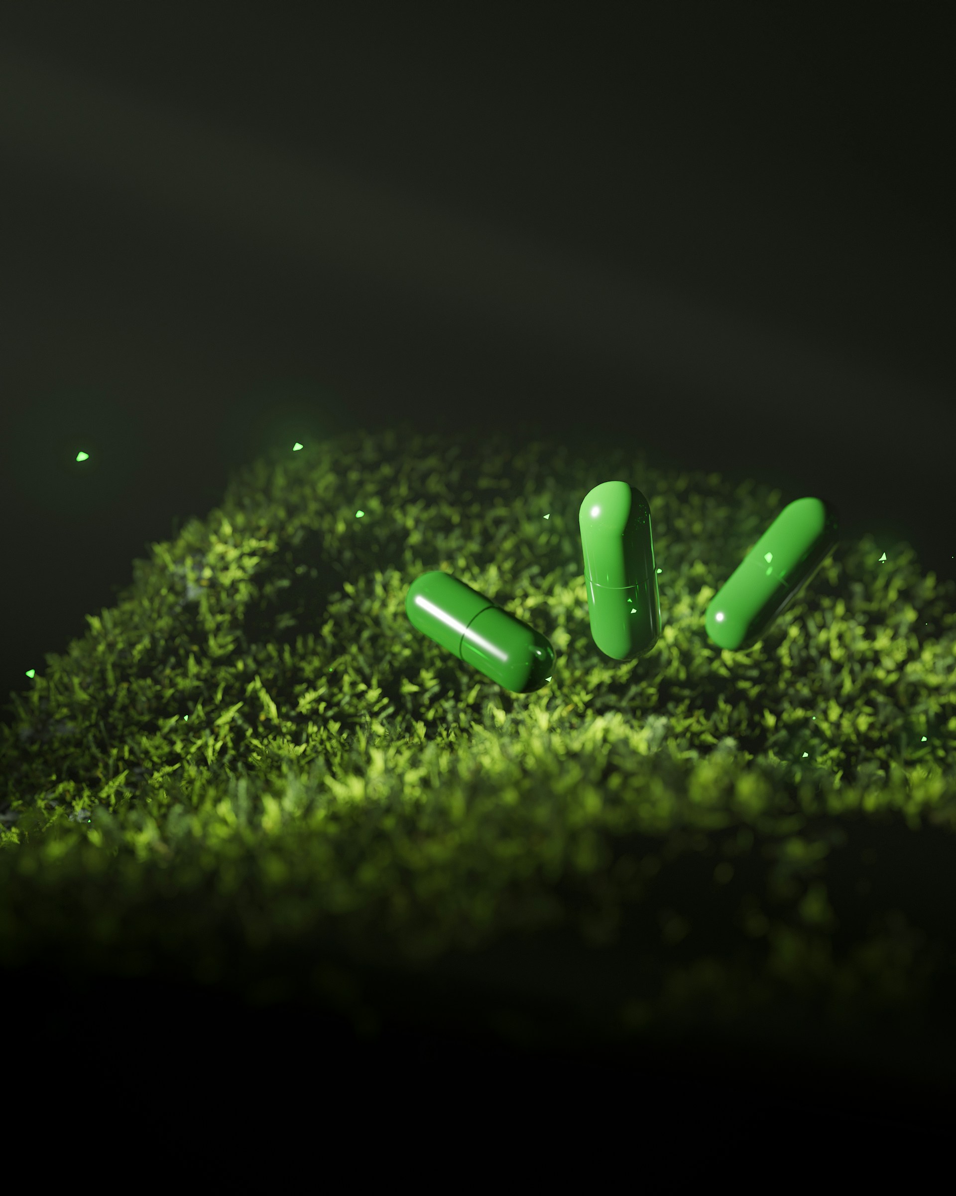 A group of green pills sitting on top of a moss covered ground