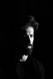 A black and white photo of a man with a beard