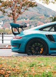 A blue sports car parked on the side of the road
