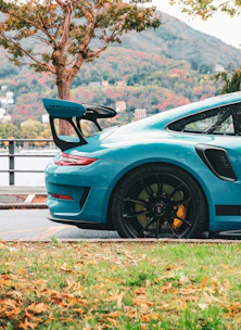 A blue sports car parked on the side of the road