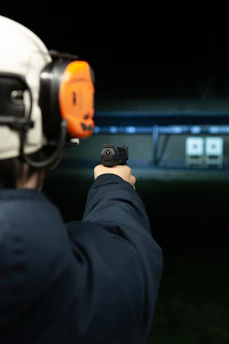 A man pointing a gun at the camera