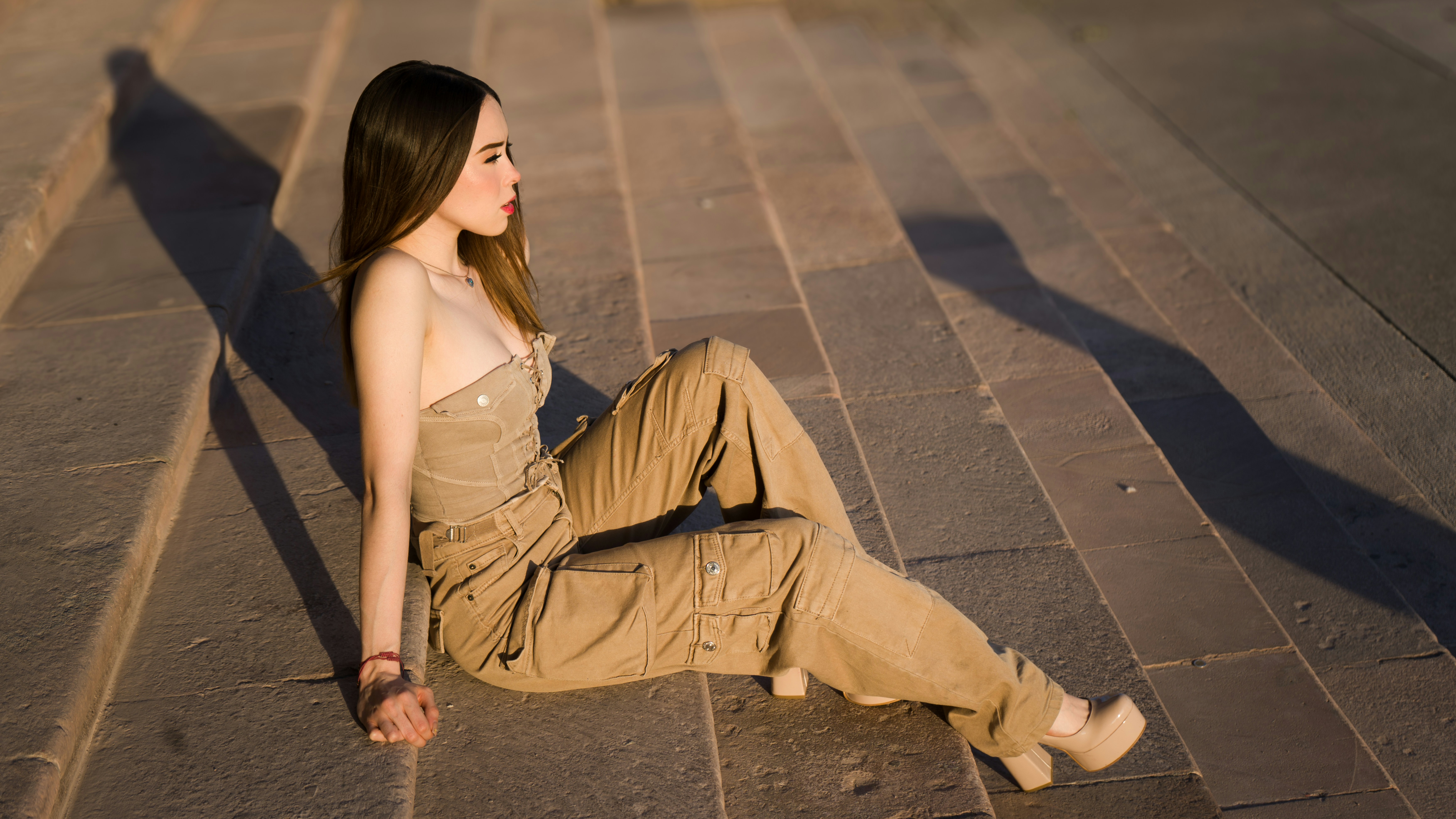 A woman sitting on the ground with her legs crossed