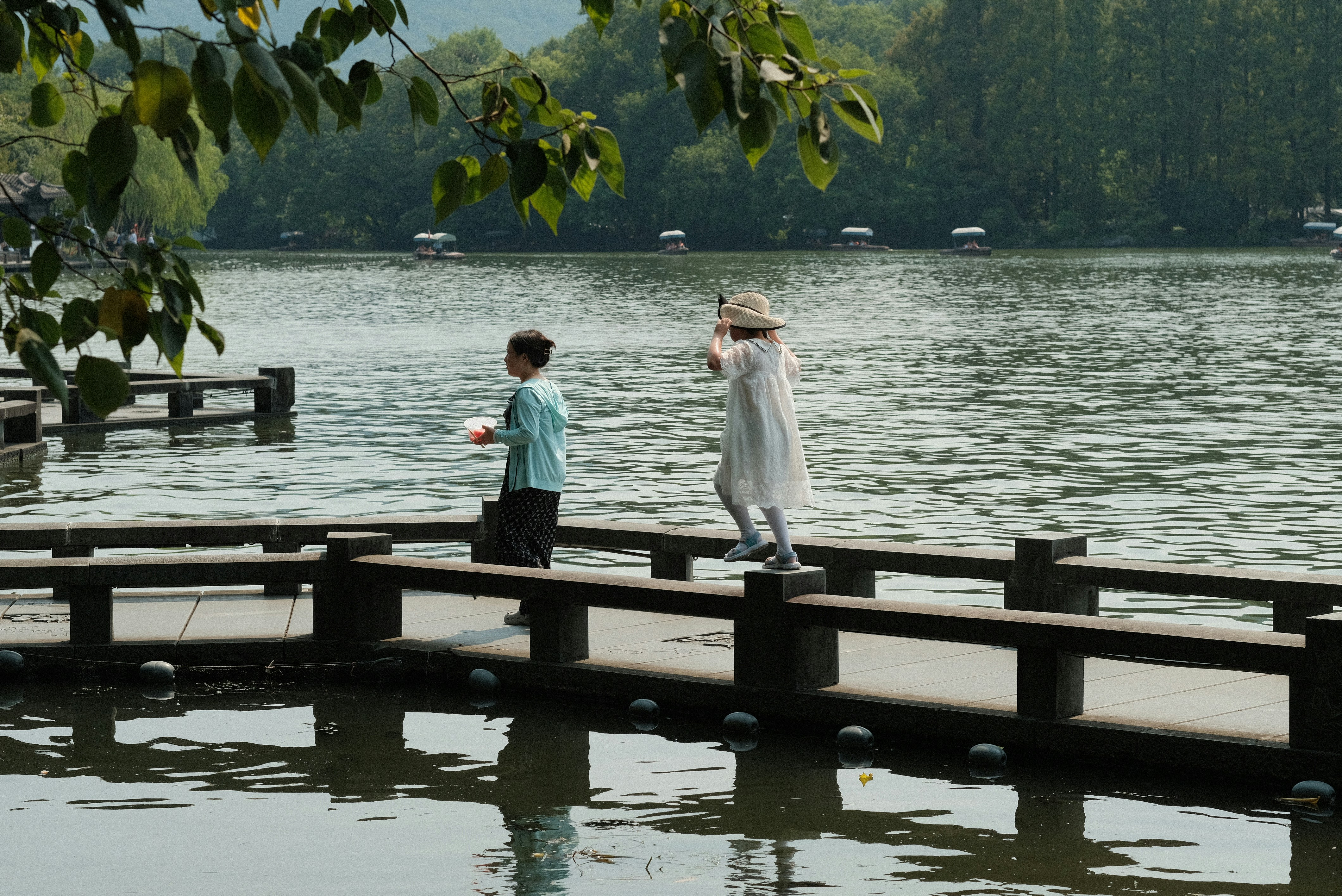 A couple of people that are standing on a pier