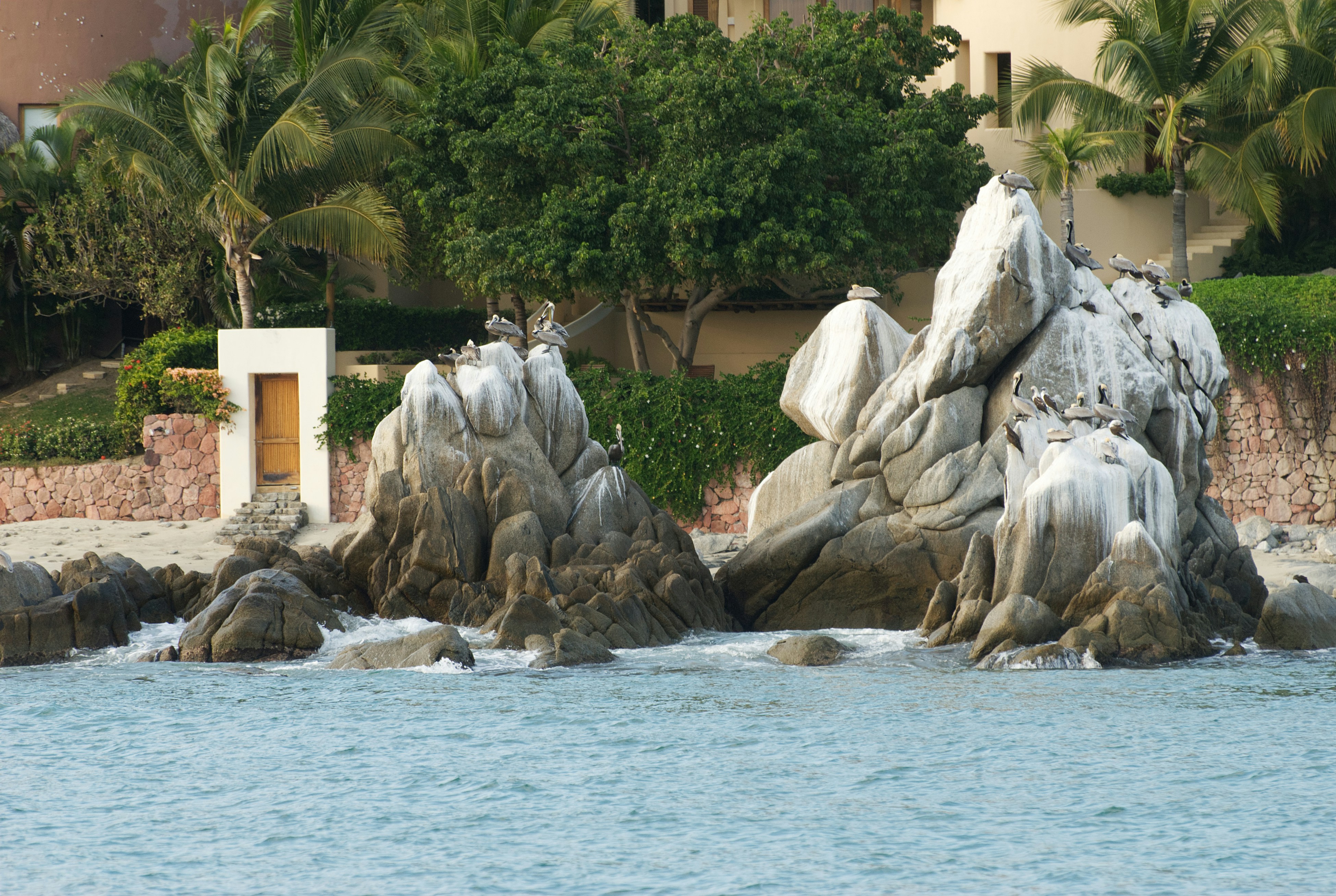 A large body of water with rocks in the middle of it