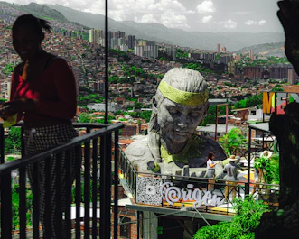 A woman standing next to a statue of a man