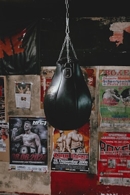 A black boxing bag hanging from a chain