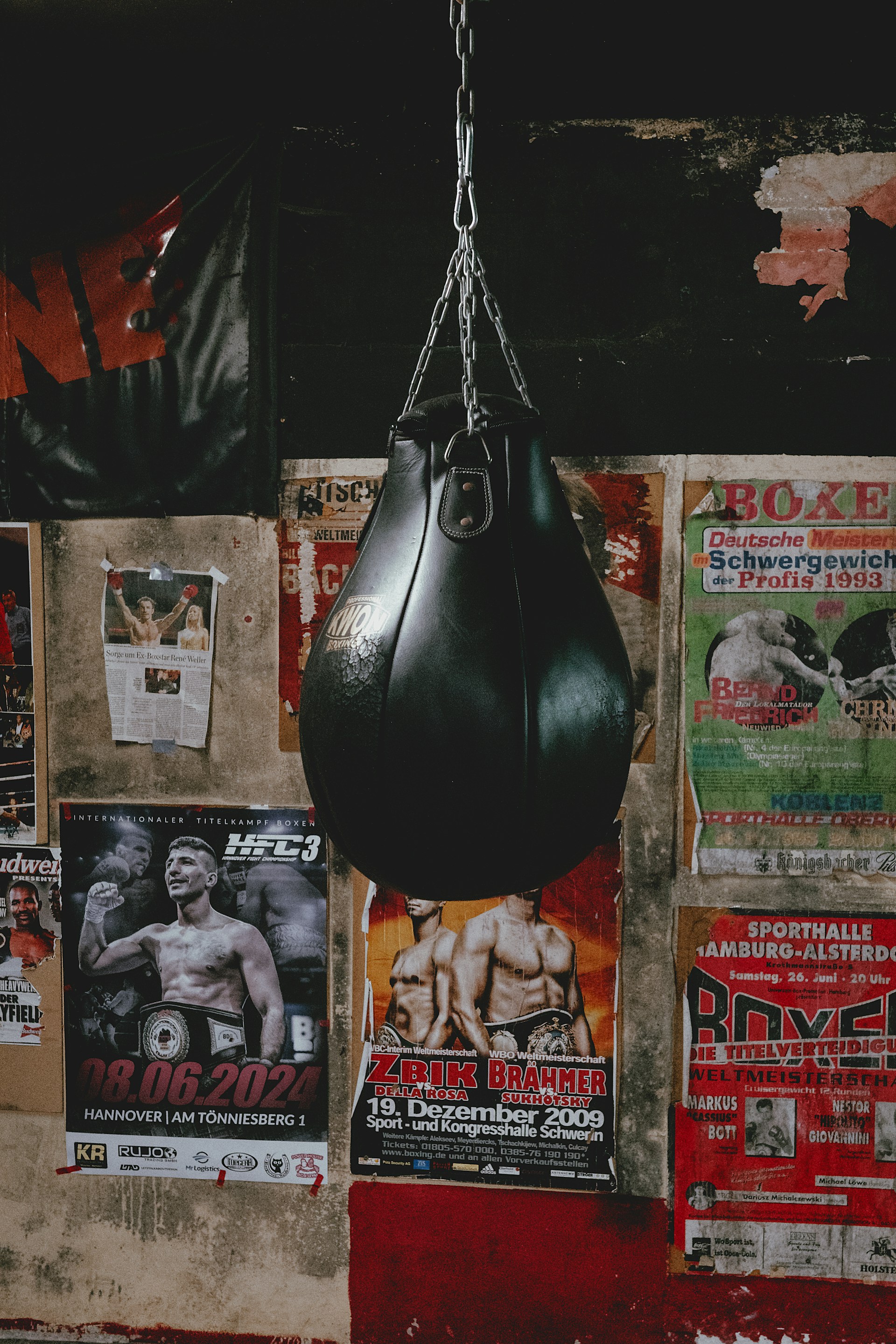 A black boxing bag hanging from a chain