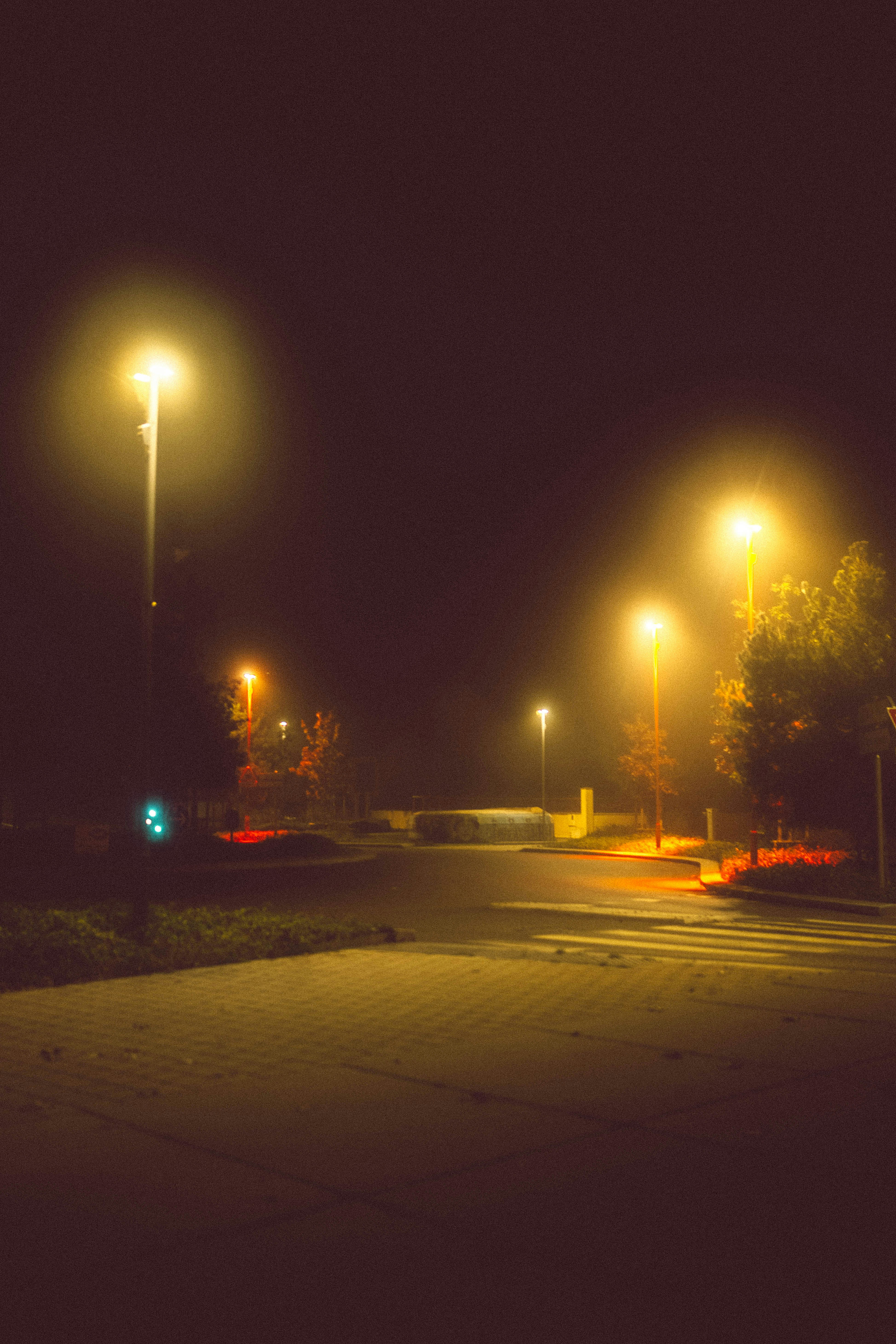 A dark street at night with street lights