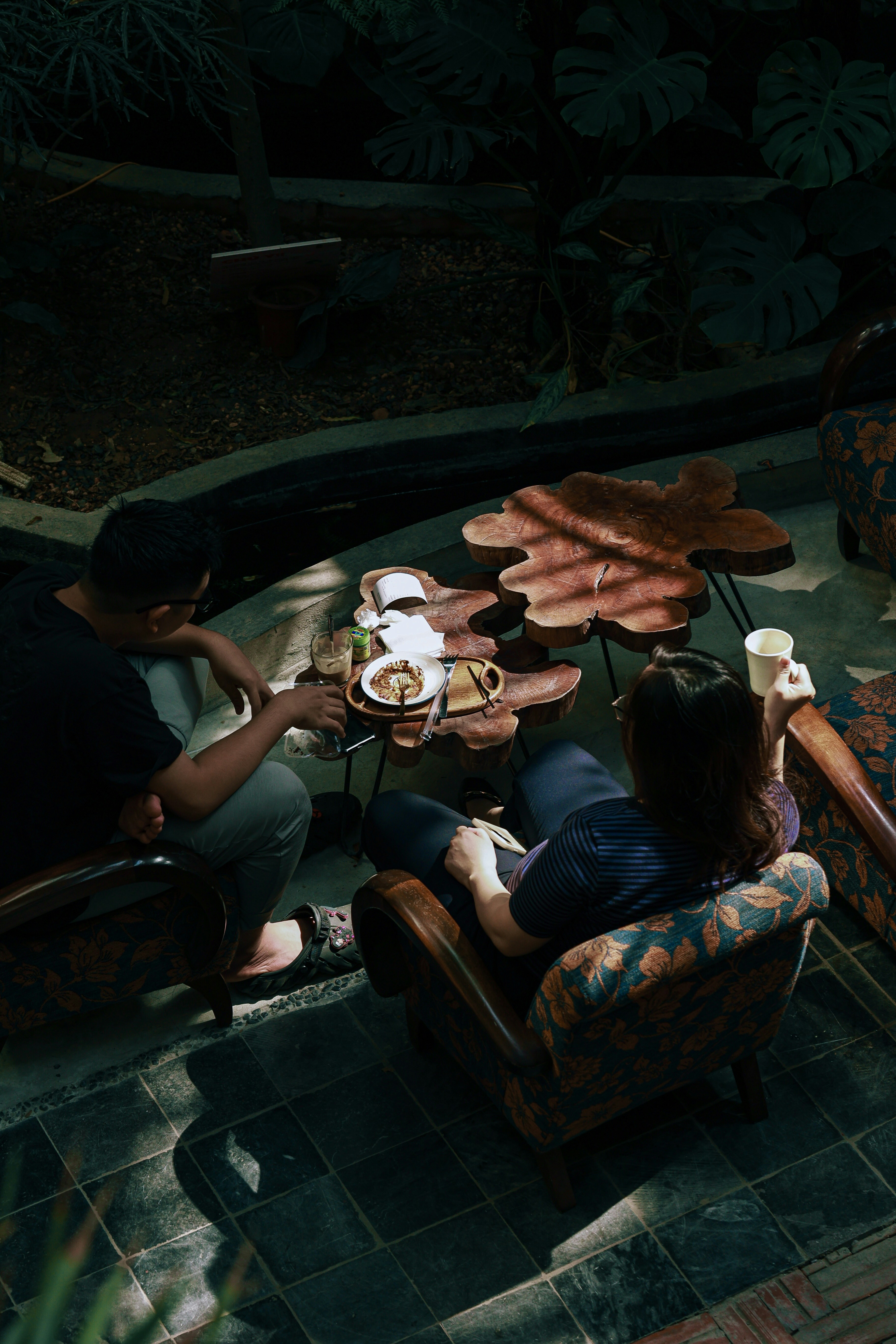 A group of people sitting around a table with food on it