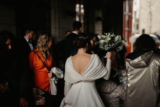 A woman in a white dress holding a bouquet of flowers