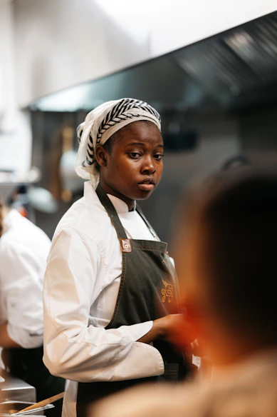 A woman in an apron standing in a kitchen