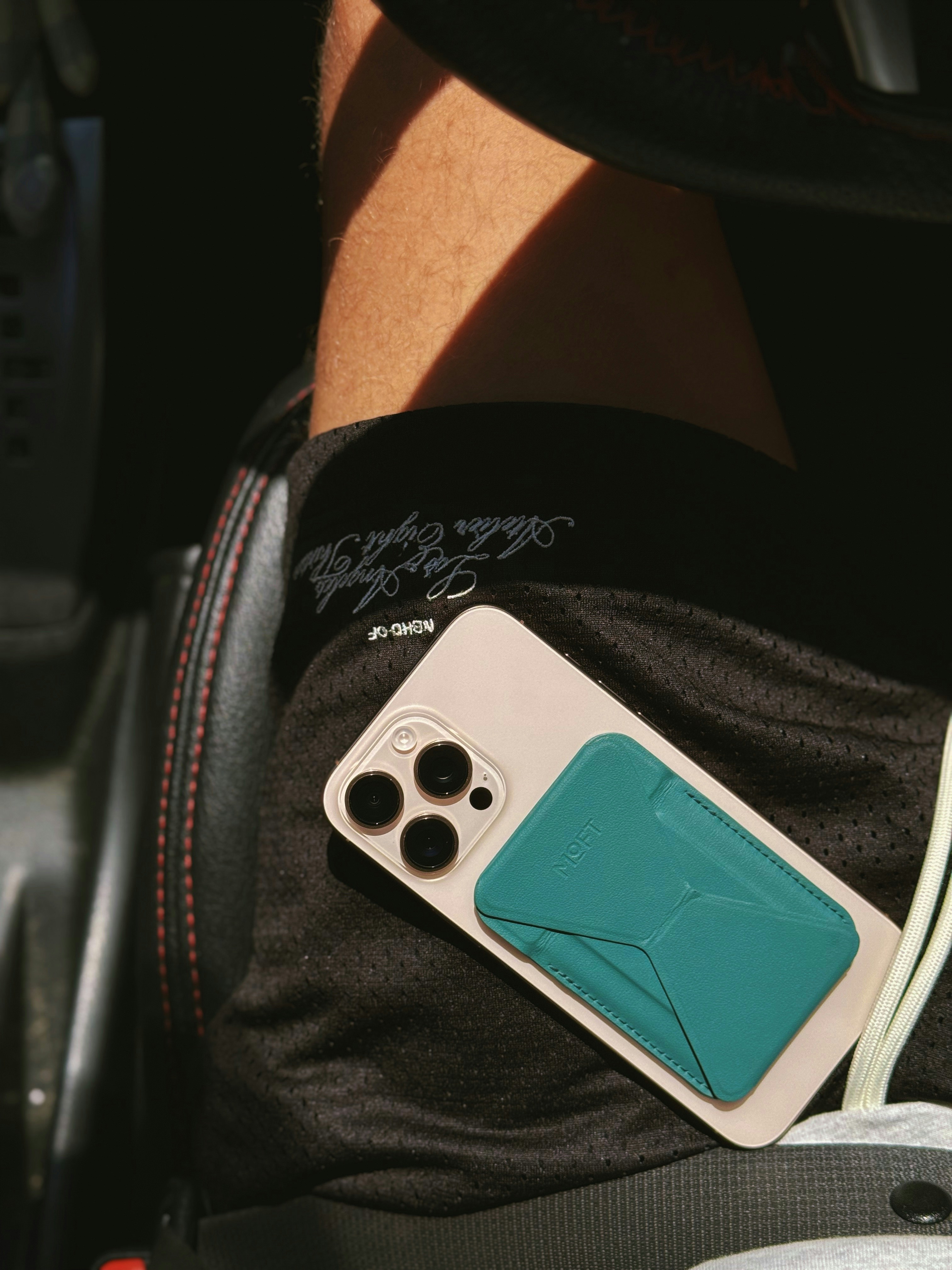 A person holding a game controller in their lap